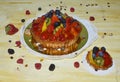 Berries, kiwi and mango on the top of the custard cake