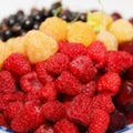 Berries plate, ripe fresh assorted, white and red raspberries, cherries, and currants