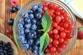 Berries of red-blue color on a dark brown wooden background healthy food Royalty Free Stock Photo