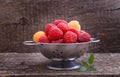 Berries red and yellow raspberries in a metal bowl Royalty Free Stock Photo