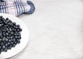 The berries ripe blueberries lying on a white plate.Summer vitamins.