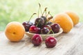 Berries of sweet cherry and apricots on a wooden table Royalty Free Stock Photo