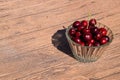 Berries of a sweet cherry in a glass bowl on a wooden background. Ripe red sweet Royalty Free Stock Photo