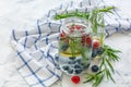 Berries and tarragon in jar with sparkling water. Royalty Free Stock Photo