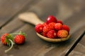 Berries of wild strawberry in a wooden spoon Royalty Free Stock Photo