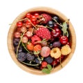 Berries in wooden bowl isolated on white. Heap of black, red and white currant, cherry, gooseberry, blackberry, strawberry, Royalty Free Stock Photo