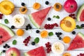 Berry background. Many summer fruits and berries are scattered on a white wooden background. Royalty Free Stock Photo