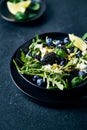 Berry (blackberry, blueberry) and arugula salad with feta, pistachios and basil