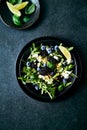 Berry (blackberry, blueberry) and arugula salad with feta, pistachios and basil