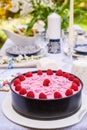 Berry cake and decorated dinner table in garden Royalty Free Stock Photo