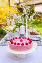 Berry cake and decorated dinner table in garden Royalty Free Stock Photo