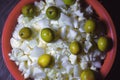 Berry and chopped cauliflower kept in a red colored basket used for vegetable and salad