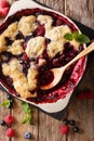 Berry cobbler with currants, raspberries and blueberries decorated with mint close up. vertical top view Royalty Free Stock Photo