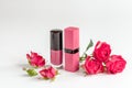 Berry color decorative cosmetics with roses white background close up