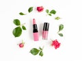 Berry color decorative cosmetics with roses white background top view
