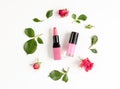 Berry color decorative cosmetics with roses white background top view