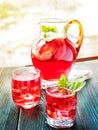 Berry compote decanter glasses with apple slices on wooden rustic background solar.