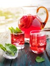 Berry compote decanter glasses with apple slices on wooden rustic background solar.