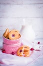 Berry cookies with milk on wooden background