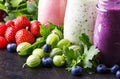 Berry fruit cokctalis, smoothies and milkshakes, fresh fruit and berries on brown table, still life, selective focus