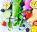 Berry and fruits smoothie in bottles, healthy summer detox yogurt drink, diet or vegan food concept