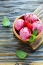 Berry ice cream with cherries in a wooden bowl. Royalty Free Stock Photo