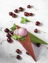 Berry ice cream in a waffle cone on a light background. Cherry ice cream. Ice cream cone with cherry, sweet cherry Royalty Free Stock Photo