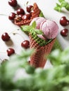 Berry ice cream in a waffle cone on a light background. Cherry ice cream. Ice cream cone with cherry, sweet cherry Royalty Free Stock Photo