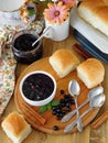 Berry jam in a ceramic bowl and golden buns Royalty Free Stock Photo