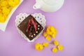 Berry jelly cake on a heart - shaped plate . Still life of a piece of cake and yellow flowers with a teapot and tea. Royalty Free Stock Photo