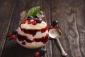 Berry mascarpone mousse dessert, on black background.