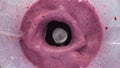 Berry milkshake splashing blender in super slow motion close up. Tasty smoothie.