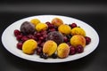 A Berry mix from frozen currant, apricot, plum, cherry. A Frozen Berries from freezer. A sweet background with frozen plum,