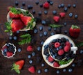 Berry mix on a wooden background. Berries in a cup and bowl. Strawberries, blueberries, blackberries and raspberries. Top view, Royalty Free Stock Photo