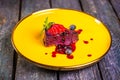 berry mousse with strawberries on a yellow plate