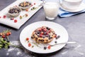 Berry muffin with blueberries and strawberries on a white plate and a wooden table served with milk and and fresh Royalty Free Stock Photo