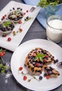 Berry muffin with blueberries and strawberries on a white plate and a wooden table served with milk and and fresh Royalty Free Stock Photo