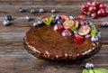 Berry pie , chocolate homemade cake with fresh blueberries and red grapes, mint on a wooden Royalty Free Stock Photo