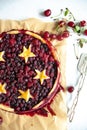 Berry pie with dough stars on a baking paper