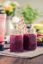 Berry smoothie on wooden table in sunny kitchen Royalty Free Stock Photo