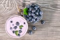 Berry smoothie or yogurt in glass and blueberries in bowl