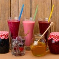 berry smoothies, jams and frozen berries Royalty Free Stock Photo