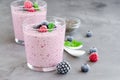 Berry smoothies of yogurt, chia seeds and frozen berries in a glass on a dark concrete background. Healthy food. Copy space Royalty Free Stock Photo