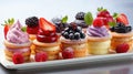 Berry sweet cakes on white background.Delicious berry mini cakes for holiday. Sweet food catering for party