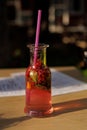 berry tea in a transparent original glass on a table in a cafe Royalty Free Stock Photo