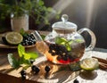 Berry tea in a transparent teapot on a wooden table