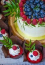 Berry wedding cake and red velvet cupcakes Royalty Free Stock Photo