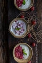 Berry yogurt dessert with gooseberry compote on wooden background Royalty Free Stock Photo