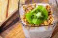 Berry youghurt with granola and fruits in a glass