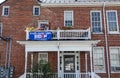 A Biden for President banner on the second floor balcony of an old house